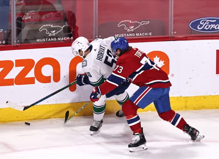 Mar 19, 2021; Montreal, Quebec, CAN; Vancouver Canucks center Bo Horvat (53) and Montreal Canadiens right wing Tyler Toffoli (73) battle for the puck during the first period at Bell Centre. Mandatory Credit: Jean-Yves Ahern-USA TODAY Sports