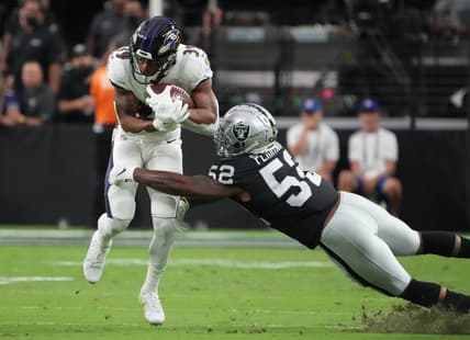 Sep 13, 2021; Paradise, Nevada, USA; Baltimore Ravens running back Trenton Cannon runs the ball against Las Vegas Raiders linebacker Denzel Perryman (52) during the first half at Allegiant Stadium. Mandatory Credit: Kirby Lee-USA TODAY Sports