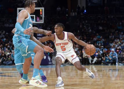 Mar 23, 2022; Charlotte, North Carolina, USA; New York Knicks guard Immanuel Quickley (5) drives past Charlotte Hornets forward center PJ Washington (25) during the first half at the Spectrum Center. Mandatory Credit: Sam Sharpe-USA TODAY Sports