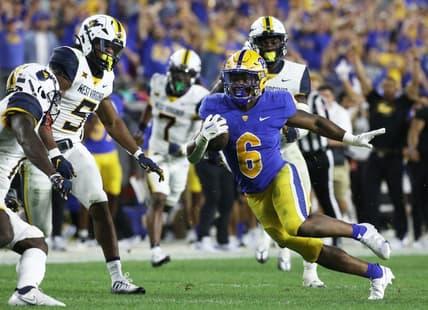 Sep 1, 2022; Pittsburgh, Pennsylvania, USA;  Pittsburgh Panthers running back Rodney Hammond Jr. (6) runs after a catch as West Virginia Mountaineers linebacker Lance Dixon (5) and cornerback Wesley McCormick (11) chase during the third quarter at Acrisure Stadium. Pittsburgh won 38-31. Mandatory Credit: Charles LeClaire-USA TODAY Sports