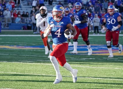 Nov 5, 2022; Lawrence, Kansas, USA; Kansas Jayhawks running back Devin Neal (4) runs the ball against the Oklahoma State Cowboys during the second half of the game at David Booth Kansas Memorial Stadium. Mandatory Credit: Denny Medley-USA TODAY Sports