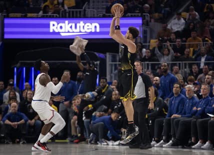 Nov 18, 2022; San Francisco, California, USA; Golden State Warriors guard Klay Thompson (11) shoots a 3-point basket over New York Knicks guard RJ Barrett (9) during the first quarter at Chase Center. Mandatory Credit: D. Ross Cameron-USA TODAY Sports