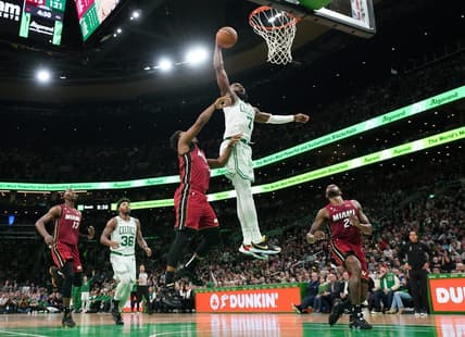 Nov 30, 2022; Boston, Massachusetts, USA; Boston Celtics guard Jaylen Brown (7) makes the dunk against Miami Heat guard Kyle Lowry (7) in the second half at TD Garden. Mandatory Credit: David Butler II-USA TODAY Sports
