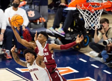 Auburn Tigers guard Wendell Green Jr. (1) and Alabama Crimson Tide player Brandon Miller (24) go after a rebound as Auburn Tigers take on Alabama Crimson Tide at Neville Arena in Auburn, Ala., on Saturday, Feb. 11, 2023. Alabama Crimson Tide defeated Auburn Tigers 77-69.