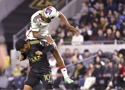 Mar 25, 2023; Los Angeles, California, USA; FC Dallas defender Nkosi Tafari (17) and Los Angeles FC forward Carlos Vela (10) go for the ball in the first half at BMO Stadium. Mandatory Credit: Jayne Kamin-Oncea-USA TODAY Sports