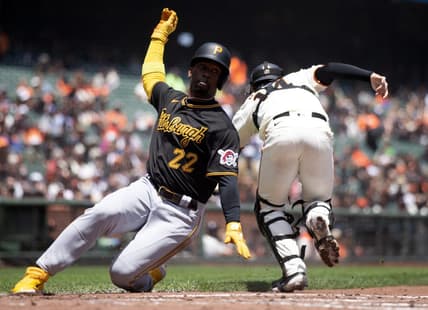 May 31, 2023; San Francisco, California, USA; Pittsburgh Pirates designated hitter Andrew McCutchen (22) slides safely home on a single by Rodolfo Castro as San Francisco Giants catcher Patrick Bailey (14) during the third inning at Oracle Park. Mandatory Credit: D. Ross Cameron-USA TODAY Sports