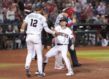 Aug 24, 2023; Phoenix, Arizona, USA; Arizona Diamondbacks center fielder Corbin Carroll (7) celebrates his two run home run with Arizona Diamondbacks left fielder Lourdes Gurriel Jr. (12) against the Cincinnati Reds during the eighth inning at Chase Field. Mandatory Credit: Joe Camporeale-USA TODAY Sports