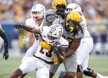Sep 9, 2023; Morgantown, West Virginia, USA; West Virginia Mountaineers defensive lineman Mike Lockhart (93) tackles Duquesne Dukes running back JaMario Clements (23) during the second quarter at Mountaineer Field at Milan Puskar Stadium. Mandatory Credit: Ben Queen-USA TODAY Sports
