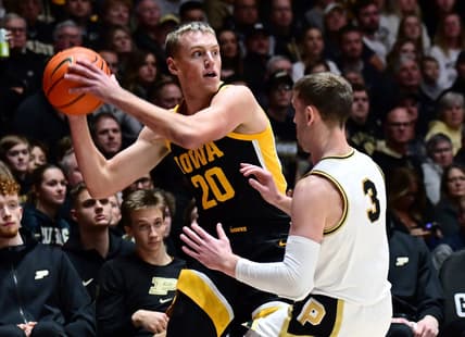 Dec 4, 2023; West Lafayette, Indiana, USA; Iowa Hawkeyes forward Payton Sandfort (20) looks to pass around Purdue Boilermakers guard Braden Smith (3) during the first half at Mackey Arena. Mandatory Credit: Marc Lebryk-USA TODAY Sports
