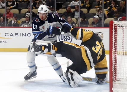 Feb 6, 2024; Pittsburgh, Pennsylvania, USA;  Winnipeg Jets center Gabriel Vilardi (13) breaks free after being held by Pittsburgh Penguins goaltender Tristan Jarry (35) during the second period at PPG Paints Arena. Mandatory Credit: Charles LeClaire-USA TODAY Sports