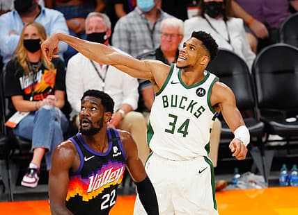 Jul 8, 2021; Phoenix, Arizona, USA; Milwaukee Bucks forward Giannis Antetokounmpo (34) against Phoenix Suns center Deandre Ayton (22) in game two of the 2021 NBA Finals at Phoenix Suns Arena. Mandatory Credit: Mark J. Rebilas-USA TODAY Sports