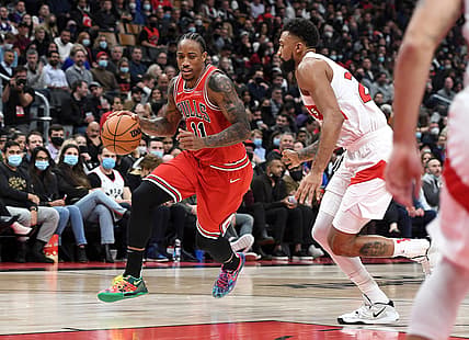 Oct 25, 2021; Toronto, Ontario, CAN; Chicago Bulls guard DeMar DeRozan (11) dribbles the ball past Toronto Raptors center Khem Birch (24) in the second half at Scotiabank Arena. Mandatory Credit: Dan Hamilton-USA TODAY Sports