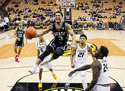 Feb 20, 2022; Columbia, Missouri, USA; Mississippi State Bulldogs guard Shakeel Moore (3) goes up for a shot as Missouri Tigers guard Jarron Coleman (5) and forward Ronnie DeGray III (21) and forward Kobe Brown (24) defend during the second half at Mizzou Arena. Mandatory Credit: Jay Biggerstaff-USA TODAY Sports