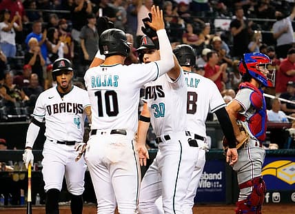 Aug 30, 2022; Phoenix, Arizona, USA; Arizona Diamondbacks Jake McCarthy (30) high-fives Josh Rojas (10) after hitting a three-run home run against the Philadelphia Phillies in the fourth inning at Chase Field. Mandatory Credit: Rob Schumacher-Arizona Republic

Mlb Phillies At Diamondbacks