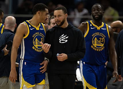 Feb 28, 2023; San Francisco, California, USA; Golden State Warriors guard Jordan Poole (3) confers with injured teammate Stephen Curry during a timeout in the fourth quarter against the Portland Trail Blazers at Chase Center. Mandatory Credit: D. Ross Cameron-USA TODAY Sports