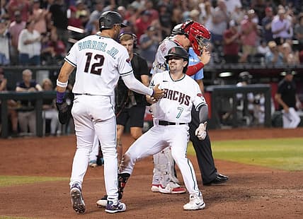 Aug 24, 2023; Phoenix, Arizona, USA; Arizona Diamondbacks center fielder Corbin Carroll (7) celebrates his two run home run with Arizona Diamondbacks left fielder Lourdes Gurriel Jr. (12) against the Cincinnati Reds during the eighth inning at Chase Field. Mandatory Credit: Joe Camporeale-USA TODAY Sports