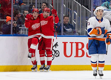 Oct 30, 2023; Elmont, New York, USA; Detroit Red Wings left wing Lucas Raymond (23) celebrates his winning goal with left wing J.T. Compher (37)against the New York Islanders during overtime at UBS Arena. Mandatory Credit: Thomas Salus-USA TODAY Sports