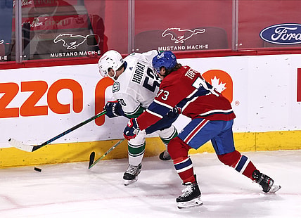Mar 19, 2021; Montreal, Quebec, CAN; Vancouver Canucks center Bo Horvat (53) and Montreal Canadiens right wing Tyler Toffoli (73) battle for the puck during the first period at Bell Centre. Mandatory Credit: Jean-Yves Ahern-USA TODAY Sports