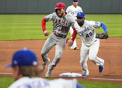 Apr 12, 2021; Kansas City, Missouri, USA; Los Angeles Angels first baseman Jared Walsh (20) avoids colliding with Kansas City Royals third baseman Hanser Alberto (49) during the second inning at Kauffman Stadium. Mandatory Credit: Jay Biggerstaff-USA TODAY Sports