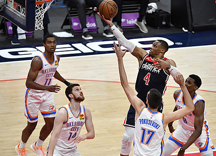 Apr 19, 2021; Washington, District of Columbia, USA; Washington Wizards guard Russell Westbrook (4) shoots over Oklahoma City Thunder forward Aleksej Pokusevski (17) and guard Svi Mykhailiuk (14) during the second quarter at Capital One Arena. Mandatory Credit: Brad Mills-USA TODAY Sports
