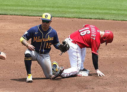 May 23, 2021; Cincinnati, Ohio, USA; Cincinnati Reds catcher Tucker Barnhart (16) is safe at second against Milwaukee Brewers second baseman Kolten Wong (16) after a wild pitch during the second inning at Great American Ball Park. Mandatory Credit: David Kohl-USA TODAY Sports