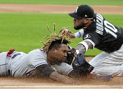 Jul 30, 2021; Chicago, Illinois, USA; Chicago White Sox third baseman Yoan Moncada (10) tags out Cleveland Indians third baseman Jose Ramirez (11) at third base during the first inning at Guaranteed Rate Field. Mandatory Credit: Mike Dinovo-USA TODAY Sports
