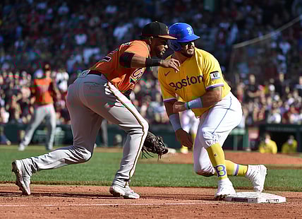Sep 18, 2021; Boston, Massachusetts, USA; Boston Red Sox left fielder Kyle Schwarber (18) safely slides in third base past Baltimore Orioles third baseman Kelvin Gutierrez (82) during the seventh inning at Fenway Park. Mandatory Credit: Bob DeChiara-USA TODAY Sports