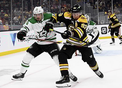 Oct 16, 2021; Boston, Massachusetts, USA;  Dallas Stars defenseman Joel Hanley (44) and Boston Bruins center Brad Marchand (63) battle for position during the first period at TD Garden. Mandatory Credit: Bob DeChiara-USA TODAY Sports