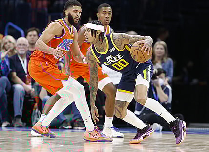 Nov 24, 2021; Oklahoma City, Oklahoma, USA; Utah Jazz guard Jordan Clarkson (00) drives to the basket around Oklahoma City Thunder forward Kenrich Williams (34) during the first half at Paycom Center. Mandatory Credit: Alonzo Adams-USA TODAY Sports