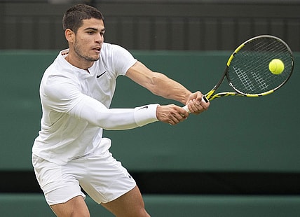 Jul 3, 2022; London, United Kingdom; Carlos Alcaraz (ESP) returns a shot during his match against Jannik Sinner (ITA) on day seven at All England Lawn Tennis and Croquet Club. Mandatory Credit: Susan Mullane-USA TODAY Sports