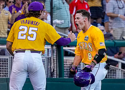 Jun 24, 2023; Omaha, NE, USA; LSU Tigers second baseman Gavin Dugas (8) celebrates with catcher Hayden Travinski (25) after scoring a home run against the Florida Gators during the third inning at Charles Schwab Field Omaha. Mandatory Credit: Dylan Widger-USA TODAY Sports