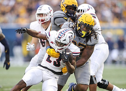 Sep 9, 2023; Morgantown, West Virginia, USA; West Virginia Mountaineers defensive lineman Mike Lockhart (93) tackles Duquesne Dukes running back JaMario Clements (23) during the second quarter at Mountaineer Field at Milan Puskar Stadium. Mandatory Credit: Ben Queen-USA TODAY Sports