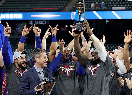 Oct 23, 2023; Houston, Texas, USA; Texas Rangers right fielder Adolis Garcia (53) holds the American League championship series MVP trophy after winning game seven in the ALCS against the Houston Astros for the 2023 MLB playoffs at Minute Maid Park. Mandatory Credit: Thomas Shea-USA TODAY Sports