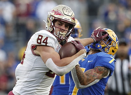Nov 4, 2023; Pittsburgh, Pennsylvania, USA;  Florida State Seminoles tight end Kyle Morlock (84) stiff arms Pittsburgh Panthers defensive back Javon McIntyre (7) after a catch during the second quarter at Acrisure Stadium. Mandatory Credit: Charles LeClaire-USA TODAY Sports