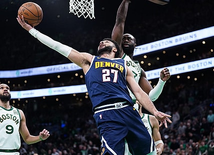 Jan 19, 2024; Boston, Massachusetts, USA; Denver Nuggets guard Jamal Murray (27) makes the basket against Boston Celtics guard Jaylen Brown (7) in the second quarter at TD Garden. Mandatory Credit: David Butler II-USA TODAY Sports