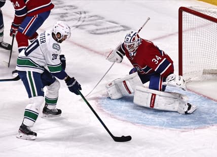 Mar 19, 2021; Montreal, Quebec, CAN; Vancouver Canucks center Brandon Sutter (20) shots the puck against Montreal Canadiens goaltender Jake Allen (34) during the first period at Bell Centre. Mandatory Credit: Jean-Yves Ahern-USA TODAY Sports