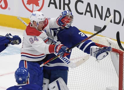 May 8, 2021; Toronto, Ontario, CAN;  Toronto Maple Leafs goalie Jack Campbell (36) holds the puck in his glove as he is bodychecked by Montreal Canadiens forward Corey Perry (94) in the first period at Scotiabank Arena. Mandatory Credit: Dan Hamilton-USA TODAY Sports