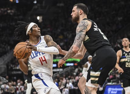 Apr 1, 2022; Milwaukee, Wisconsin, USA; LA Clippers guard Terance Mann (14) drives for the basket against Milwaukee Bucks forward Sandro Mamukelashvili (54) in the second quarter at Fiserv Forum. Mandatory Credit: Benny Sieu-USA TODAY Sports