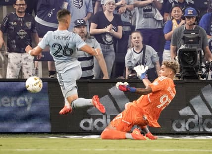 Sep 17, 2022; Kansas City, Kansas, USA; Sporting Kansas City midfielder Eric Thammy (26) kicks a shot on goal as Minnesota United goalkeeper Dayne St. Clair (97) defends during the first half of the match at Children's Mercy Park. Mandatory Credit: Denny Medley-USA TODAY Sports