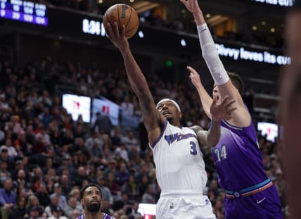 Dec 22, 2022; Salt Lake City, Utah, USA;  Washington Wizards guard Bradley Beal (3) tries to keep Utah Jazz center Walker Kessler (24) away from the ball while shooting during the second half at Vivint Arena. Mandatory Credit: Chris Nicoll-USA TODAY Sports