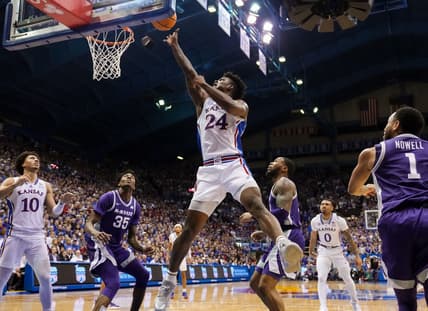 Jan 31, 2023; Lawrence, Kansas, USA; Kansas Jayhawks forward K.J. Adams Jr. (24) shoots against Kansas State Wildcats forward Nae'Qwan Tomlin (35) and guard Desi Sills (13) during the second half at Allen Fieldhouse. Mandatory Credit: Jay Biggerstaff-USA TODAY Sports