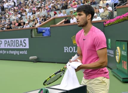 Mar 19, 2023; Indian Wells, CA, USA;  Carlos Alcaraz (ESP) wipes off his racket during the match as he defeated Daniil Medvedev (RUS) in the men   s final of the BNP Paribas Open at the Indian Wells Tennis Garden. Mandatory Credit: Jayne Kamin-Oncea-USA TODAY Sports