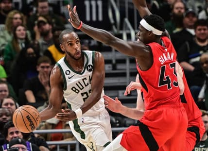 Mar 19, 2023; Milwaukee, Wisconsin, USA; Milwaukee Bucks forward Khris Middleton (22) looks to pass against Toronto Raptors forward Pascal Siakam (43) in the fourth quarter at Fiserv Forum. Mandatory Credit: Benny Sieu-USA TODAY Sports