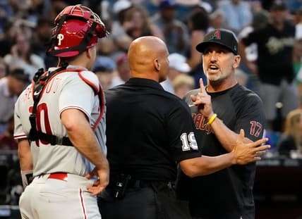 Jun 12, 2023; Phoenix, AZ, USA; Arizona Diamondbacks manager Torey Lovullo (17) urges with Philadelphia Phillies catcher J.T. Realmuto (10) after Corbin Carroll was hit by a pitch for the second time in the game in the third inning at Chase Field. Mandatory Credit: Rob Schumacher-Arizona Republic