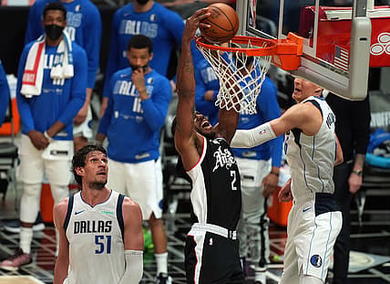 Jun 6, 2021; Los Angeles, California, USA; Los Angeles Clippers forward Kawhi Leonard (2) moves in for a basket against Dallas Mavericks center Kristaps Porzingis (6) and center Boban Marjanovic (51) during the second half in game seven of the first round of the 2021 NBA Playoffs. at Staples Center. Mandatory Credit: Kirby Lee-USA TODAY Sports