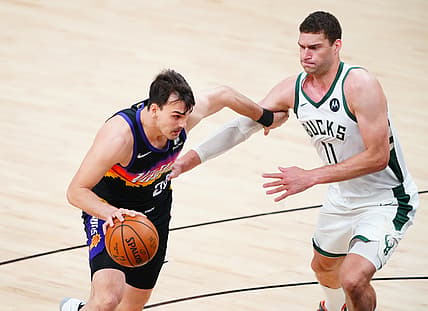 Jul 6, 2021; Phoenix, Arizona, USA; Phoenix Suns forward Dario Saric (20) drives to the basket against Milwaukee Bucks center Brook Lopez (11) during game one of the 2021 NBA Finals at Phoenix Suns Arena. Mandatory Credit: Mark J. Rebilas-USA TODAY Sports