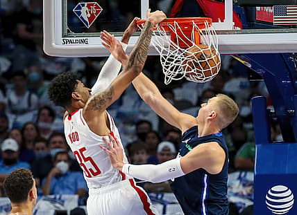 Oct 26, 2021; Dallas, Texas, USA;  Houston Rockets center Christian Wood (35) dunks past Dallas Mavericks center Kristaps Porzingis (6) during the first quarter at American Airlines Center. Mandatory Credit: Kevin Jairaj-USA TODAY Sports