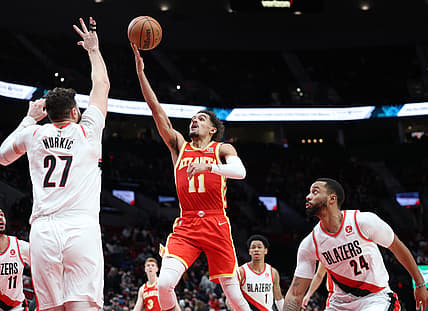 Jan 3, 2022; Portland, Oregon, USA;  Atlanta Hawks guard Trae Young (11) shoots over Portland Trail Blazers center Jusuf Nurkic (27) in the second half at Moda Center. Mandatory Credit: Jaime Valdez-USA TODAY Sports