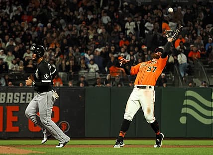 Jul 1, 2022; San Francisco, California, USA; San Francisco Giants shortstop Donovan Walton (37) makes a catch near Chicago White Sox first baseman Jose Abreu (79) during the sixth inning at Oracle Park. Mandatory Credit: Kelley L Cox-USA TODAY Sports