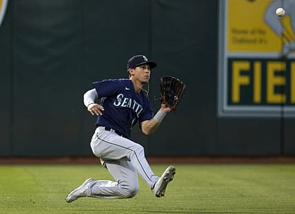 Aug 19, 2022; Oakland, California, USA; Seattle Mariners left fielder Sam Haggerty (0) makes a sliding catch against the Oakland Athletics during the fifth inning at RingCentral Coliseum. Mandatory Credit: D. Ross Cameron-USA TODAY Sports